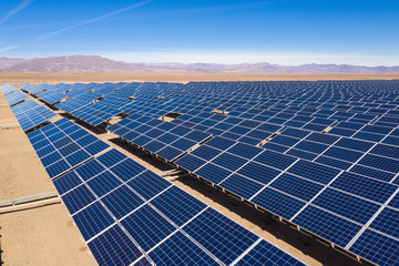 Aerial view of hundreds solar energy modules or panels rows along the dry lands at Atacama Desert,...