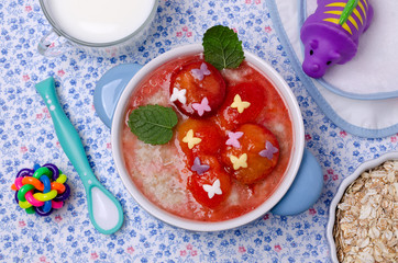 Oatmeal for baby feeding with plum jam