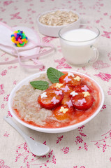 Oatmeal for baby feeding with plum jam