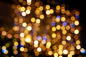 Gold glittering christmas lights. Blurred abstract background.