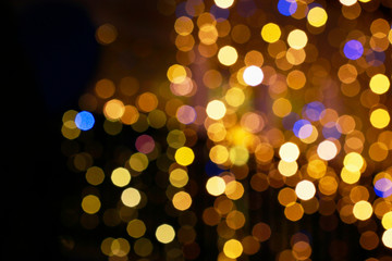Gold glittering christmas lights. Blurred abstract background.