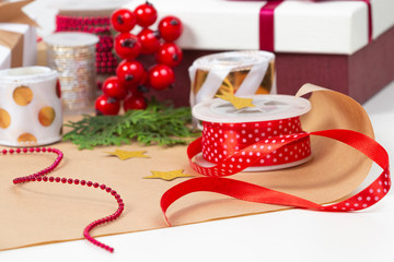 Christmas background with gifts present box, wrapping paper, ribbons, bows on white table