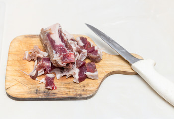 minced meat in the kitchen with a knife on a cutting board