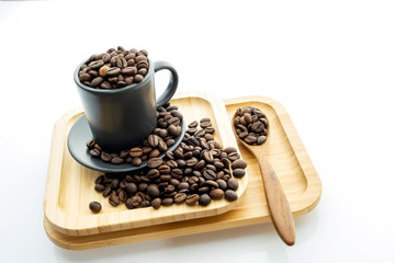 Coffee beans in a coffee mug on a white background