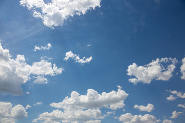 Naklejka na ściany i meble Clouds in the bright sky in the summer