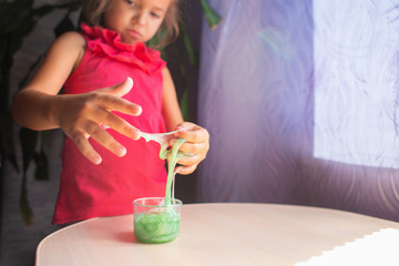 The girl unsticks from the hands of the stuck green slime