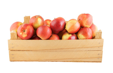 Red apples in wooden box isolated on white