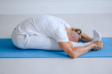 Man doing yoga at home. fitness, yoga and healthy lifestyle concept