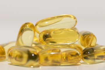 Omega fat capsules on white background