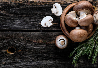  Brown mushrooms on old dark wooden background