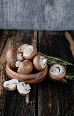  Brown mushrooms on old dark wooden background