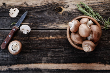  Brown mushrooms on old dark wooden background