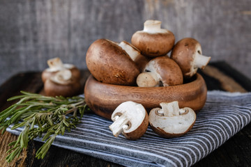  Brown mushrooms on old dark wooden background