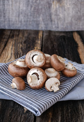  Brown mushrooms on old dark wooden background
