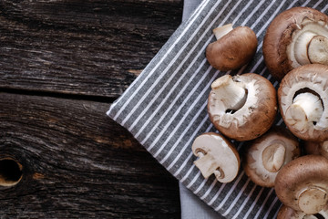  Brown mushrooms on old dark wooden background