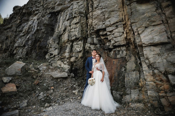 newlyweds on the background of rocks