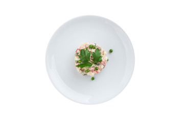 Russian traditional salad Olivier with parsley isolated on white background