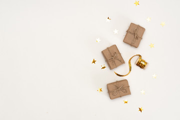 Christmas composition. Gift, christmas golden decorations, cypress branches, pine cones on white background. Flat lay, top view
