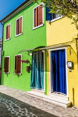 Fototapeta na wymiar Bright yellow-green house on Burano island