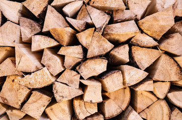 Background image - harvested firewood. The concept of rural life, summer harvesting for the winter, retro, wood, natural materials. Place for text, minimalism.