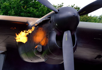 Flames from exhaust of Lancaster bomber Merlin piston engine on start up.