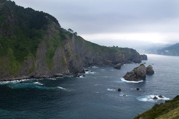 cliffs with fog seen from gaztelugatxe, vizcaya, spain