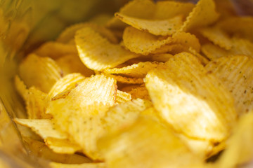 Corrugated potato chips in a pack, close-up.Selective focus