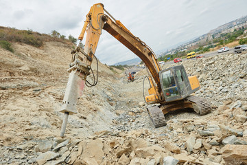 hydraulic breaker hammer excavator at demolition work © Kadmy