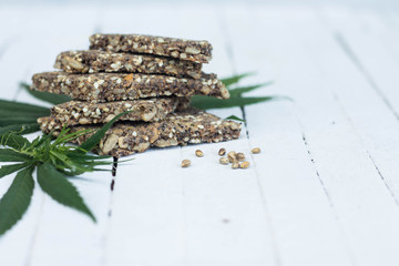 cannabis cookies and green leaves copy space