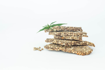 cannabis cookies and green leaves isolated