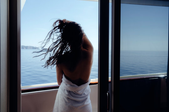silhouette of woman looking out the window, flying hair