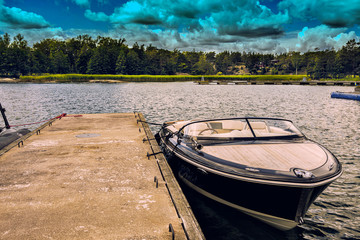 Luxury yacht on the water at the harbour with clouds summer sky background