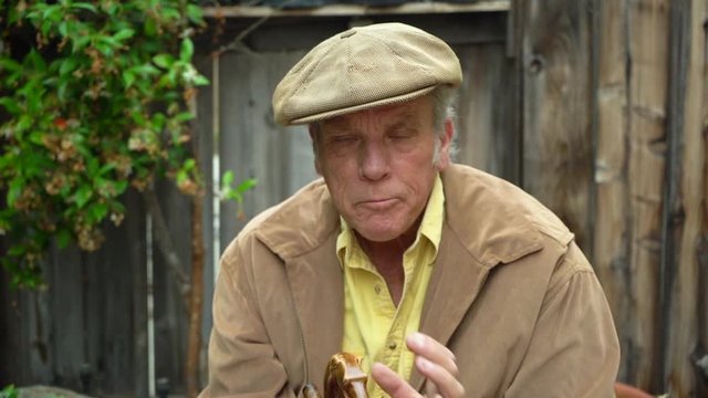 Old grouchy man making threatening gestures with his cane, holding cigar, funny clip