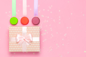 Gift or present box beautiful festive ribbon cake macaron or macaroon confetti on pink background top view. Flat lay composition for celebration holiday birthday, Valentine's Day, March 8, mother day