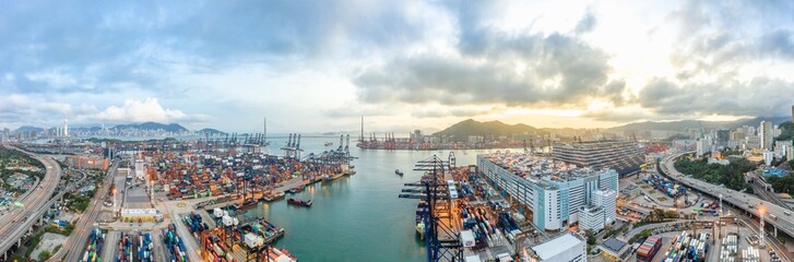 Panoramic aerial view of Hong Kong port industrial district, Stonecutters Bridge, and city on sunset skyline background. Logistic industry, Asia cityscape landscape, or transportation business concept - obrazy, fototapety, plakaty