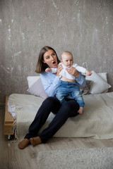 Naklejka premium Caucasian Mother and Daughter Sitting on Bed