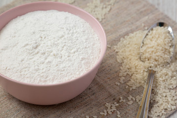 Gluten free rice flour in a pink bowl, side view. Closeup.