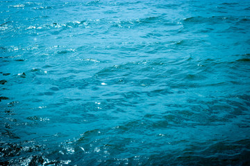 Blue azure water in the sea. Waves on the surface of the water. Abstract background.