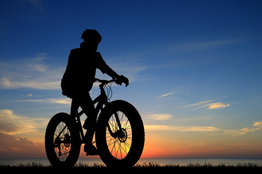 Silhouette  Cycling  on blurry sunrise  sky   background.