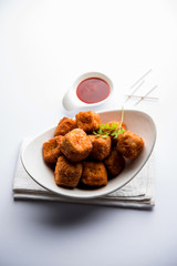Crispy Paneer popcorn is a popular party snack and an appetiser. selective focus