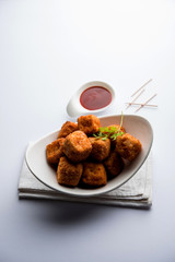 Crispy Paneer popcorn is a popular party snack and an appetiser. selective focus