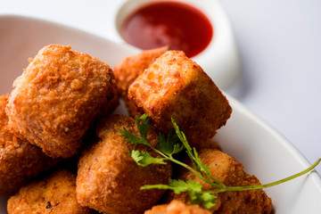 Crispy Paneer popcorn is a popular party snack and an appetiser. selective focus