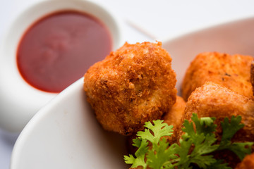 Crispy Paneer popcorn is a popular party snack and an appetiser. selective focus