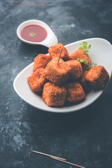 Crispy Paneer popcorn is a popular party snack and an appetiser. selective focus