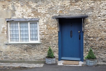 Fototapeta na wymiar old blue door in stone wall