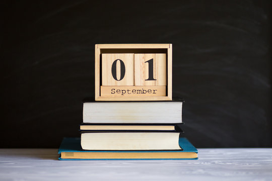 Notepads on table in front of chalk board. Back to school concept with copy space