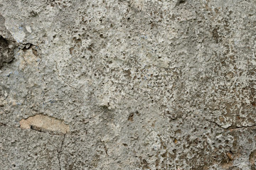 Texture of a concrete wall with cracks and scratches which can be used as a background