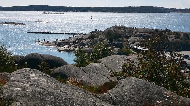 People bathing on cliffs in the swedish archipelago outside Gothenburg