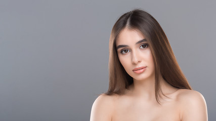 Fototapeta premium Young nude gorgeous woman portrait, grey panorama background