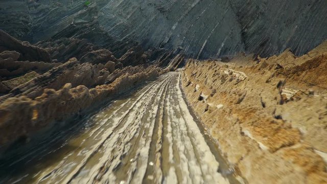 Low camera moves through rocky facies